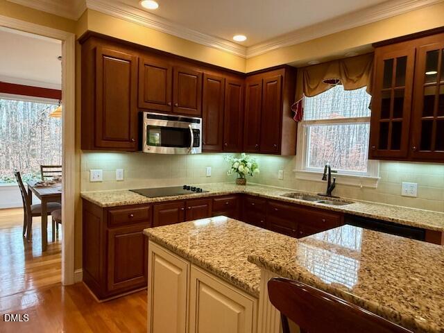 534 Dink Ashley Road Timberlake, NC 27583 - Photo 33 of 86 a kitchen with granite countertop wooden cabinets and a stove top oven