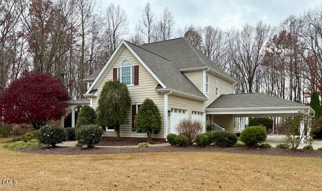 534 Dink Ashley Road Timberlake, NC 27583 - Photo 4 of 86 a view of a white house with a large windows and flower plants