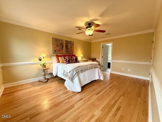 534 Dink Ashley Road Timberlake, NC 27583 - Photo 51 of 86 a bedroom with a bed ceiling fan and a wooden floor