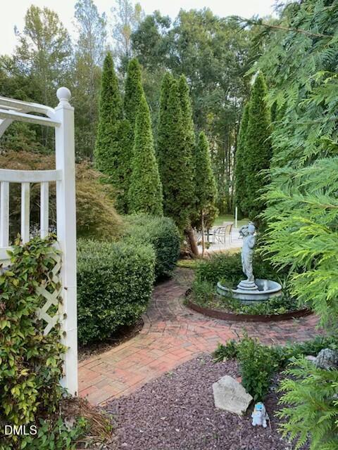 534 Dink Ashley Road Timberlake, NC 27583 - Photo 79 of 86 a view of a garden with large trees