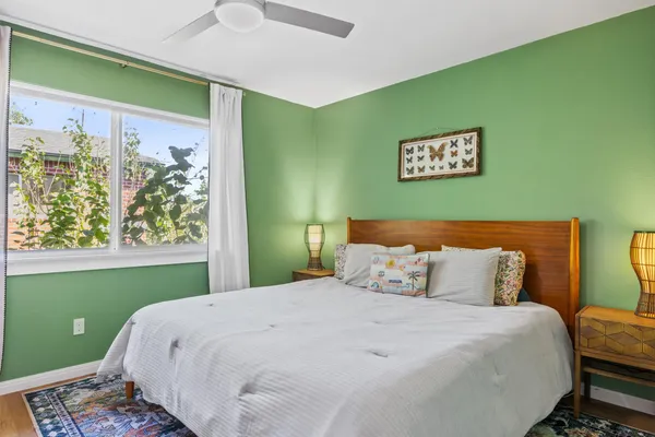 a bedroom with a bed and a mirror