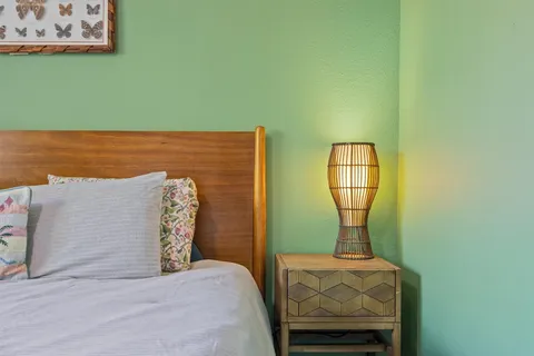 a bed sitting in a bedroom next to a bathroom