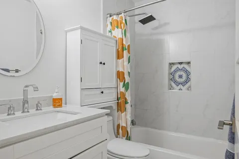 a bathroom with a sink a toilet and a mirror