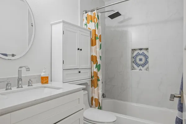 a bathroom with a sink a toilet and a mirror