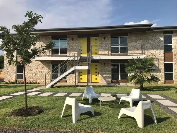 a view of a house with backyard porch and sitting area