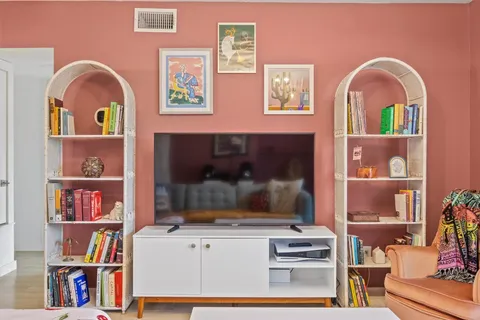 a bedroom with furniture and a large window