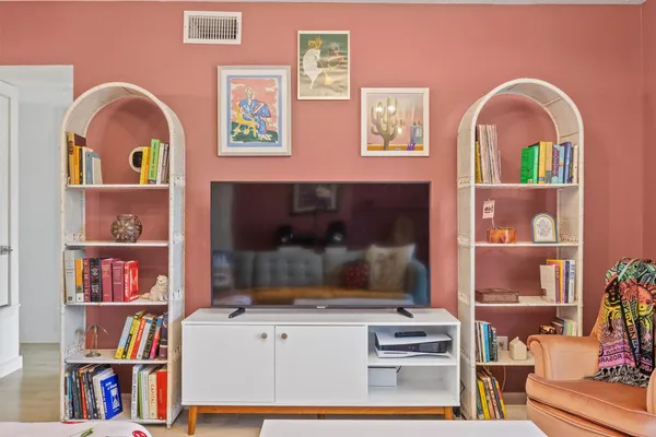 a bedroom with furniture and a large window