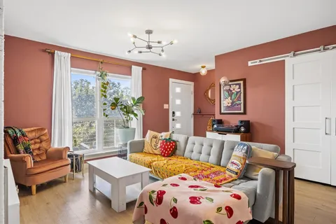 a bedroom with furniture and a large window