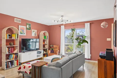 a bedroom with furniture and a wooden floor