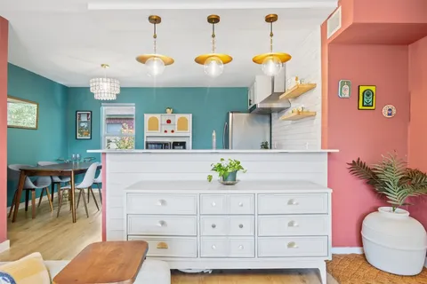 a living room with furniture and a potted plant