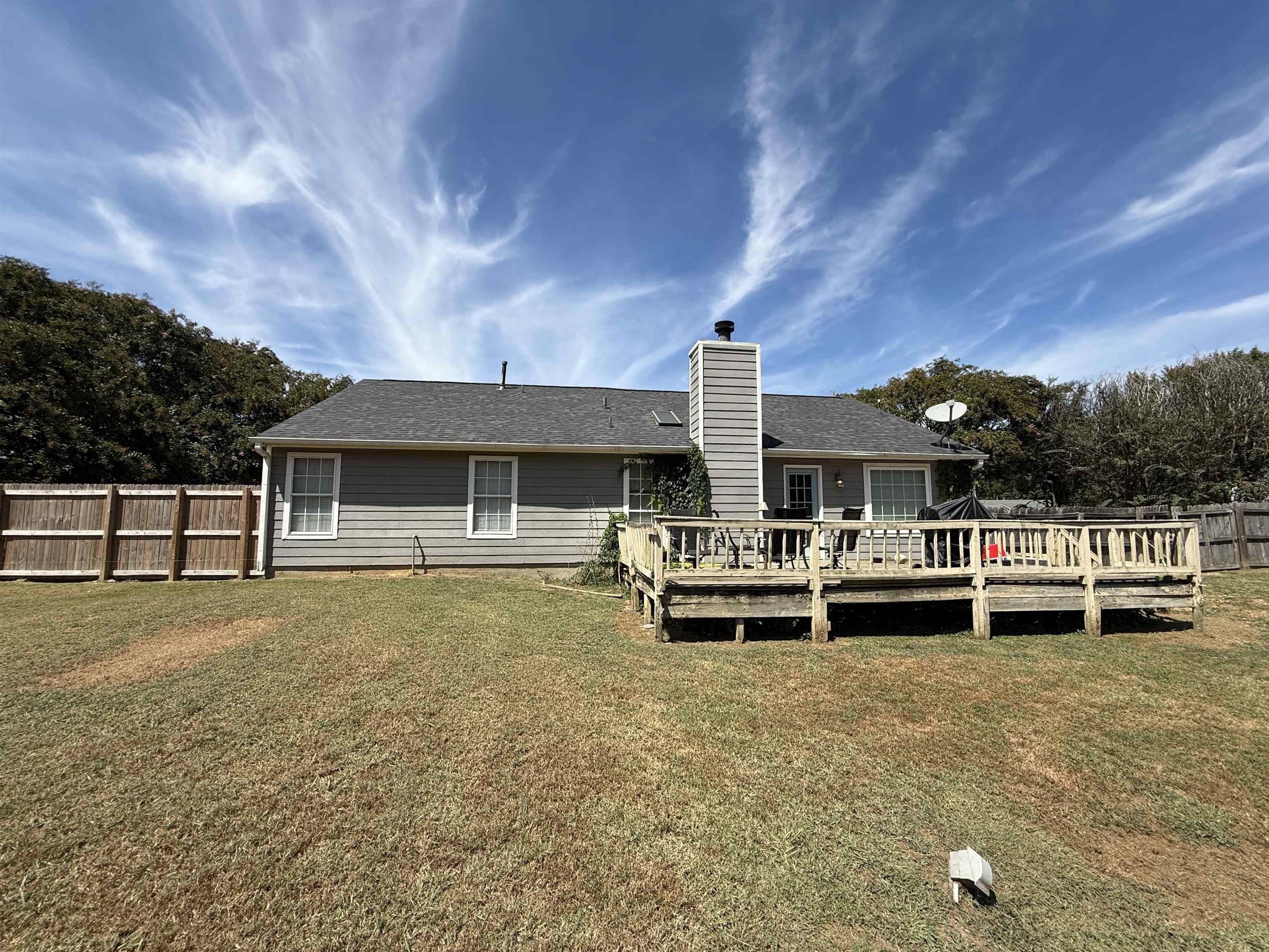 663 Tracy Road Millington, TN 38053 - Photo 14 of 21 Rear view of house featuring a deck, a chimney, and a shingled roof