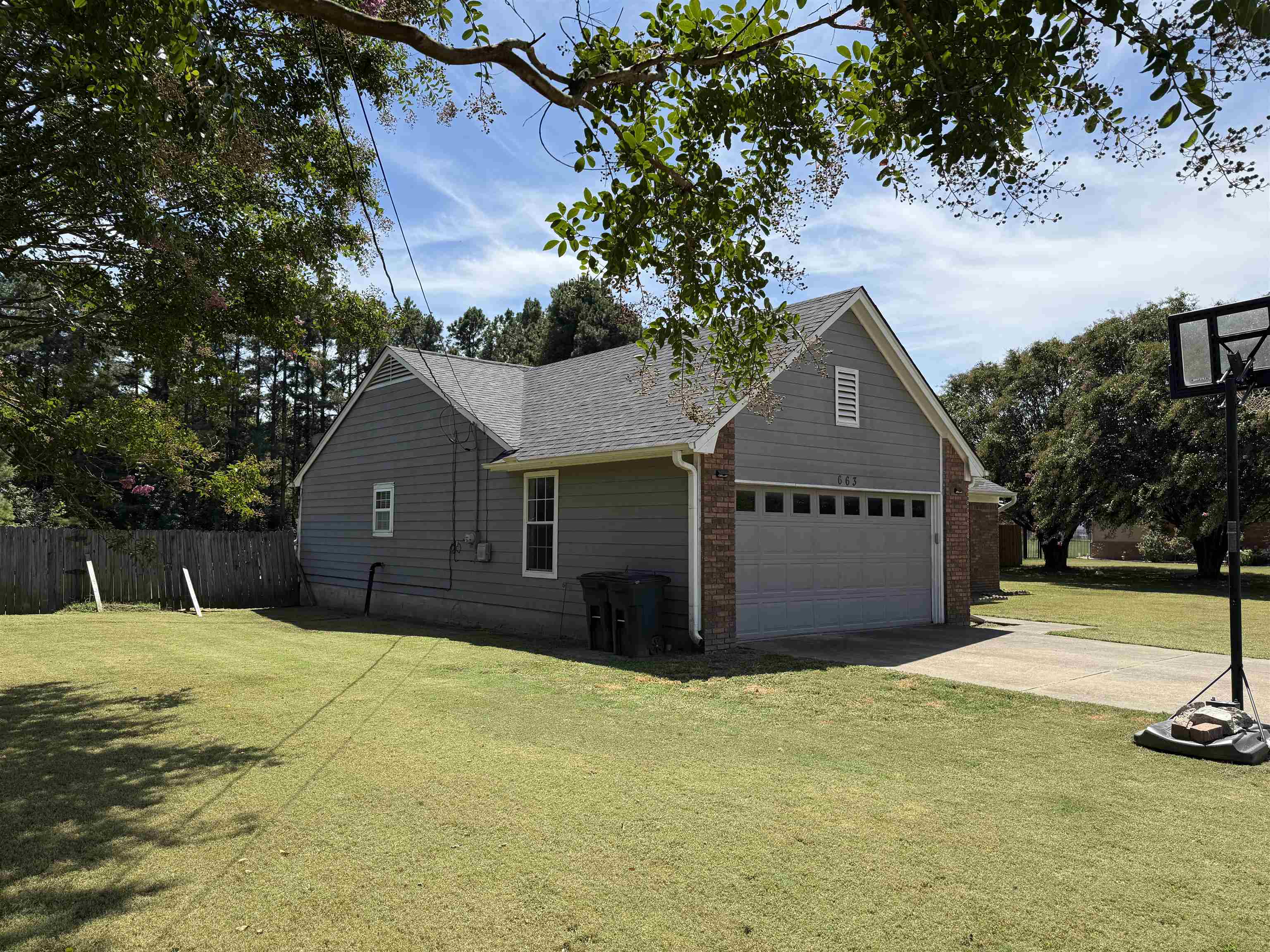 663 Tracy Road Millington, TN 38053 - Photo 4 of 21 View of side of home with driveway and roof with shingles