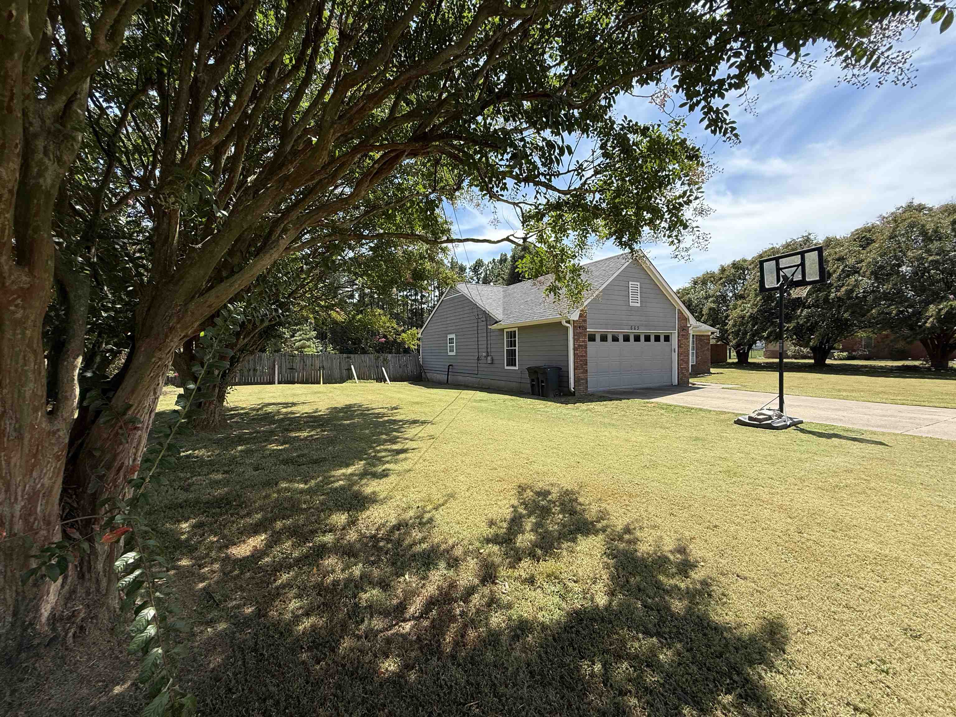 663 Tracy Road Millington, TN 38053 - Photo 5 of 21 View of yard featuring a garage and concrete driveway