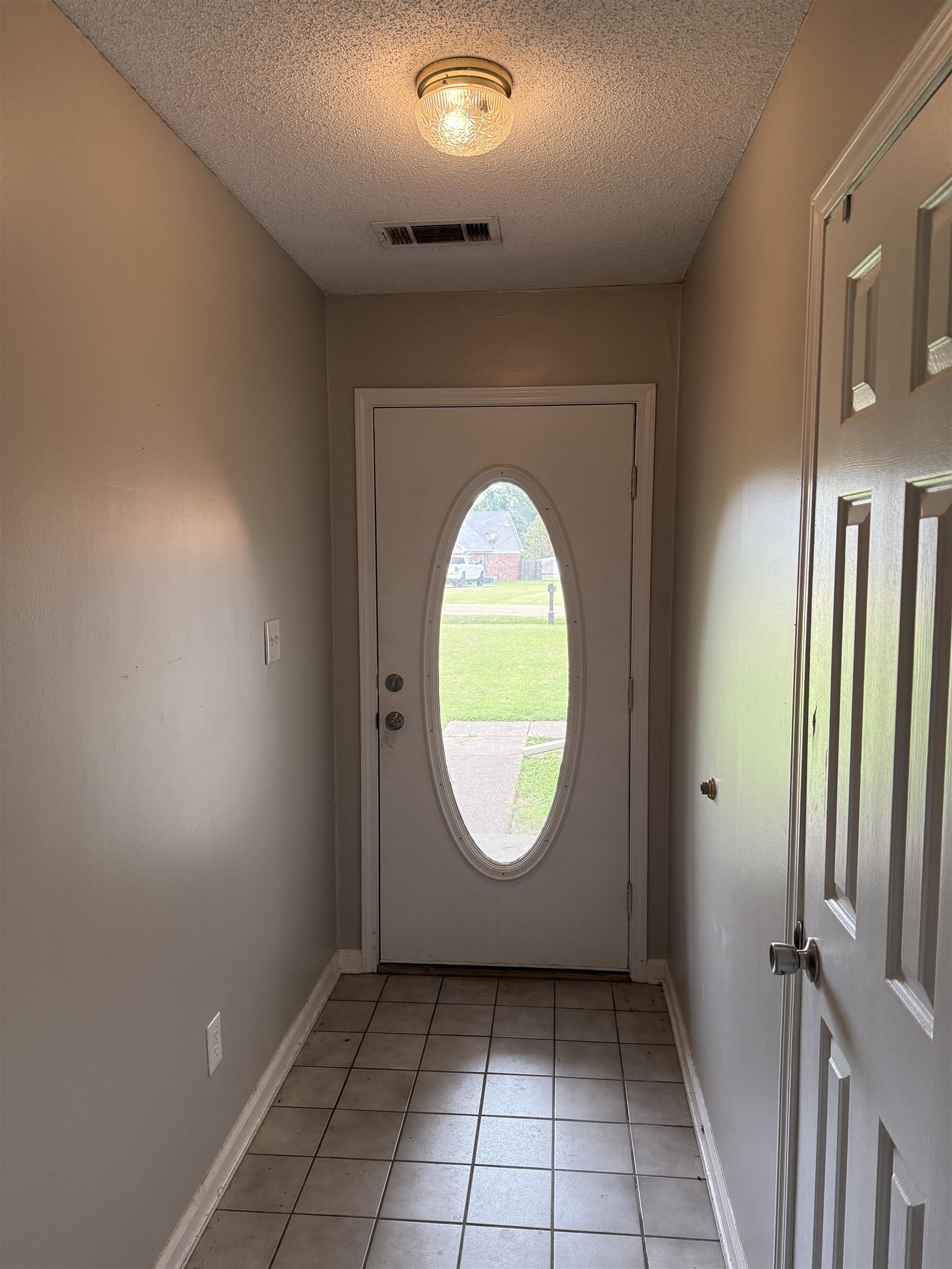 663 Tracy Road Millington, TN 38053 - Photo 10 of 21 Doorway with tile patterned floors and a textured ceiling