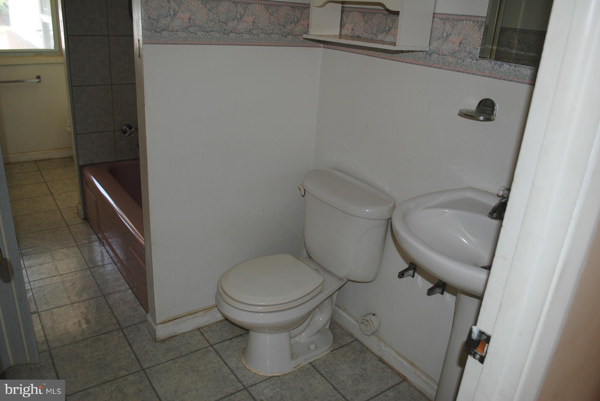 1941 Winder Road Baltimore, MD 21244 - Photo 22 of 22 a white toilet sitting next to a small sink