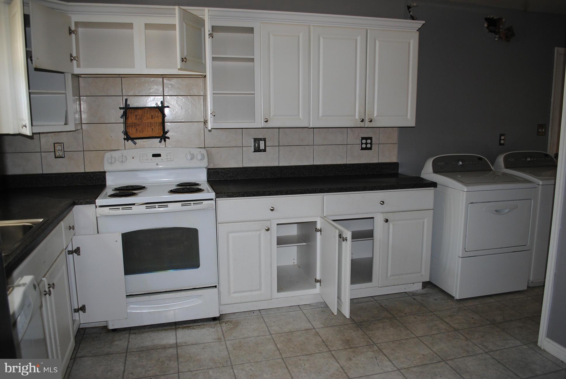 1941 Winder Road Baltimore, MD 21244 - Photo 4 of 22 a kitchen with white cabinets and appliances