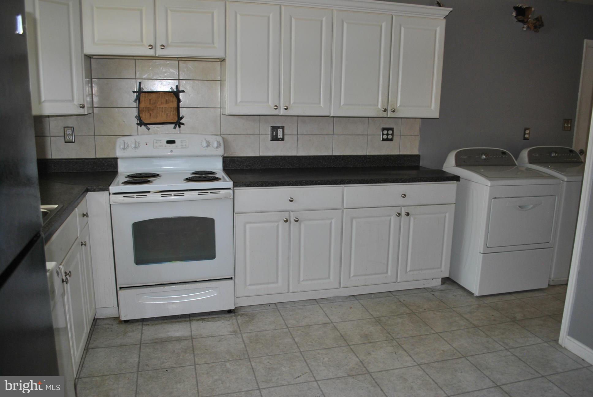 1941 Winder Road Baltimore, MD 21244 - Photo 5 of 22 a kitchen with white cabinets and white appliances