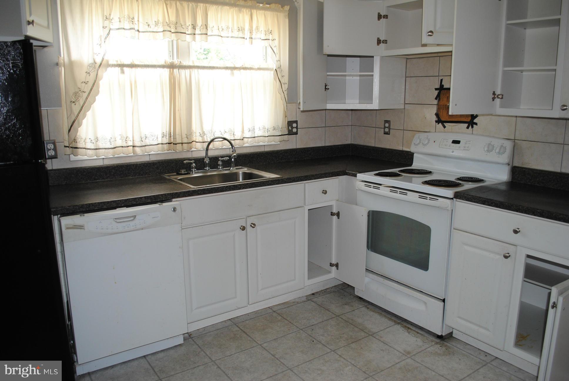 1941 Winder Road Baltimore, MD 21244 - Photo 6 of 22 a kitchen with granite countertop white cabinets and a sink