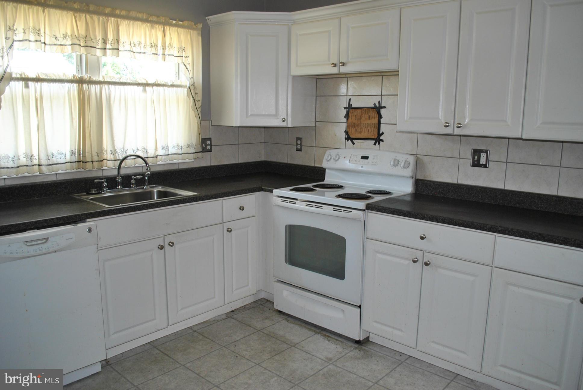 1941 Winder Road Baltimore, MD 21244 - Photo 7 of 22 a kitchen with granite countertop white cabinets white appliances and a sink