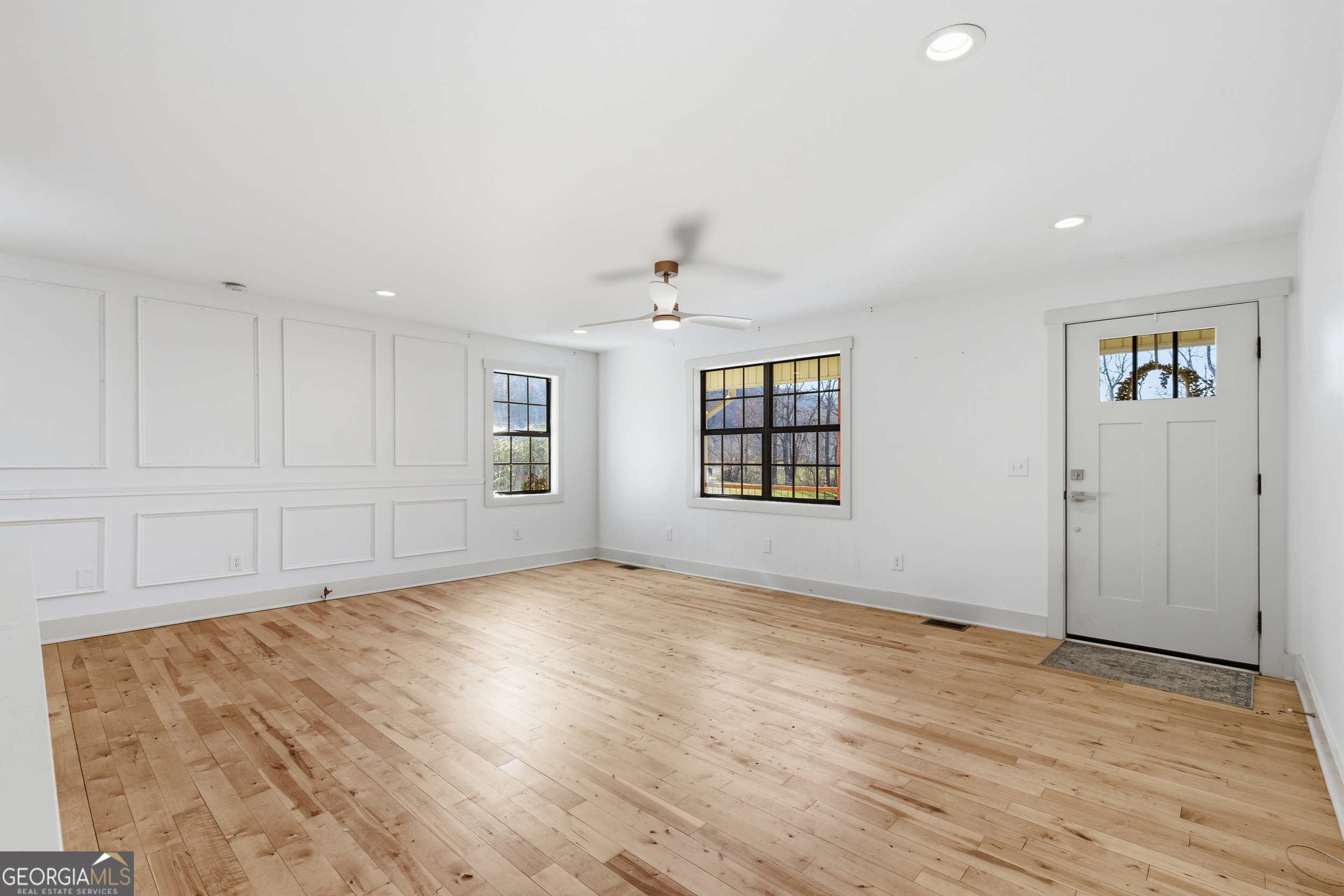 1664 Bell Gap Road Hiawassee, GA 30546 - Photo 14 of 42 an empty room with wooden floor and windows