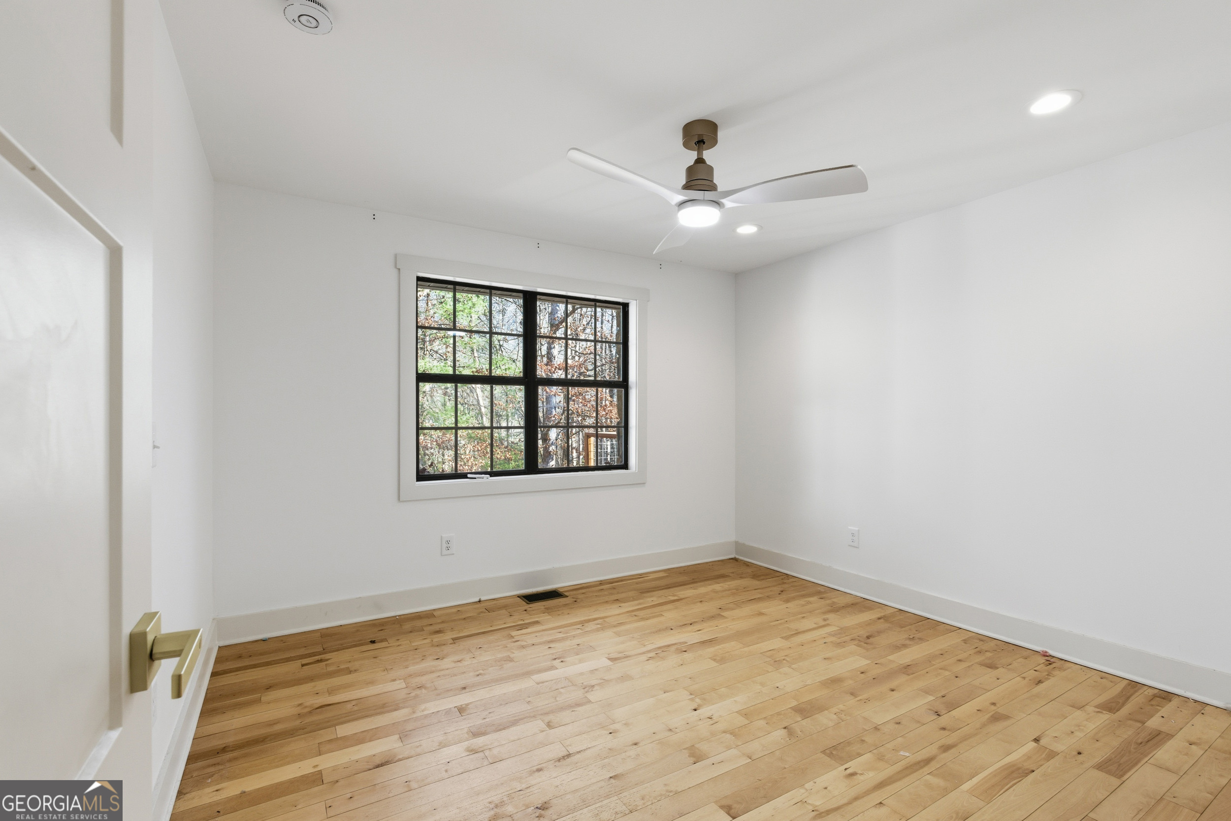 1664 Bell Gap Road Hiawassee, GA 30546 - Photo 26 of 42 an empty room with a window and ceiling fan