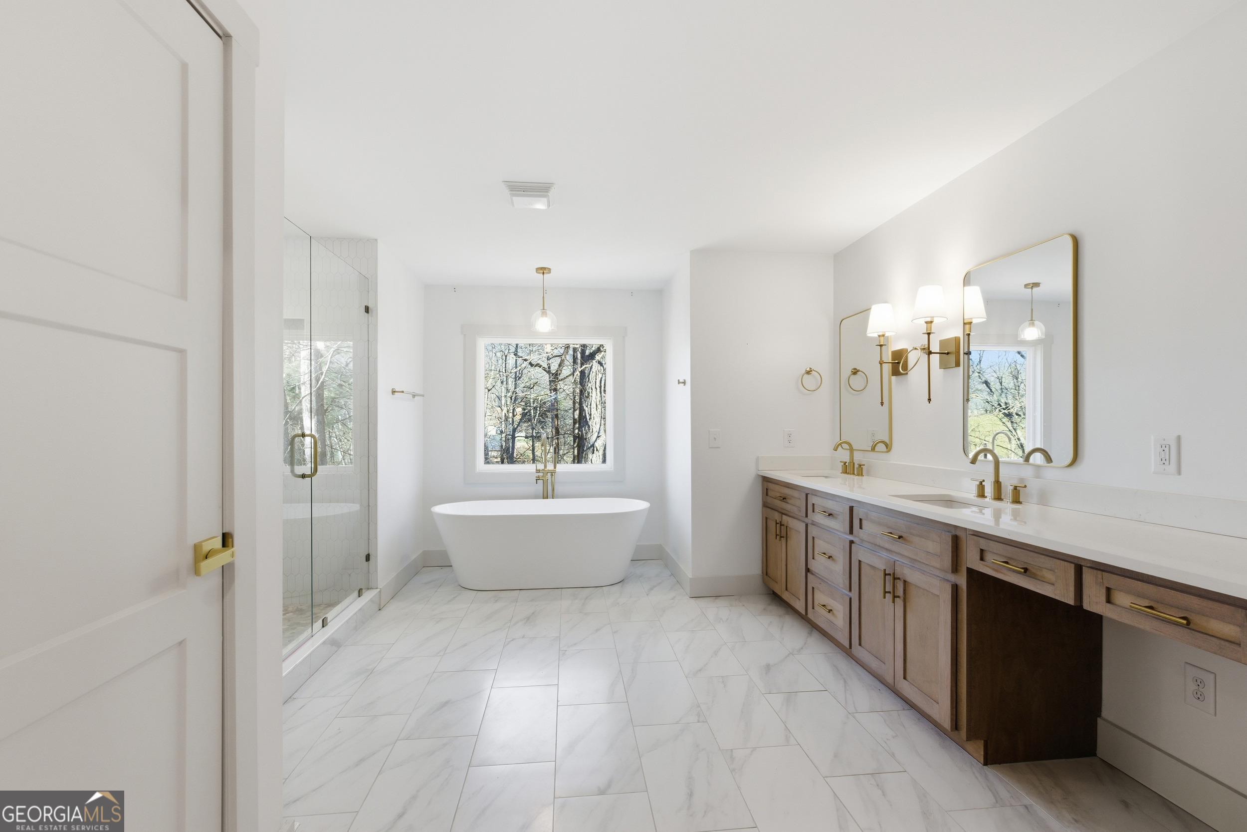 1664 Bell Gap Road Hiawassee, GA 30546 - Photo 3 of 42 a large bathroom with a double vanity sink a large mirror and a bathtub