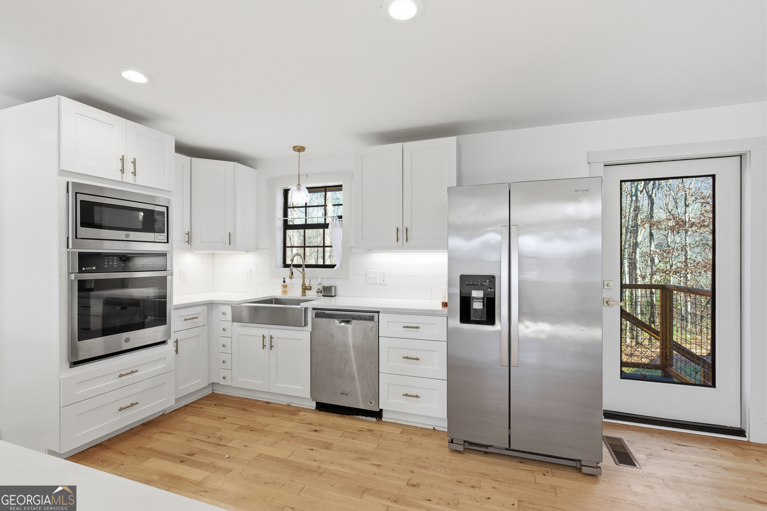 1664 Bell Gap Road Hiawassee, GA 30546 - Photo 10 of 42 a kitchen with stainless steel appliances granite countertop a refrigerator and a stove top oven