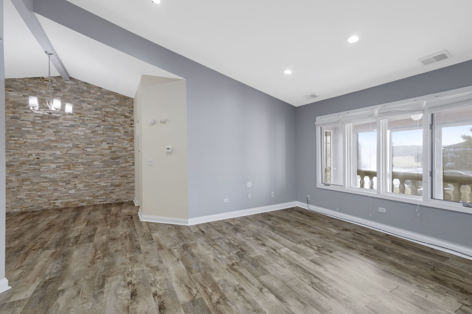 9724 West Creek Road, Unit E2 Palos Park, IL 60464 - Photo 2 of 11 a view of empty room with wooden floor and fan