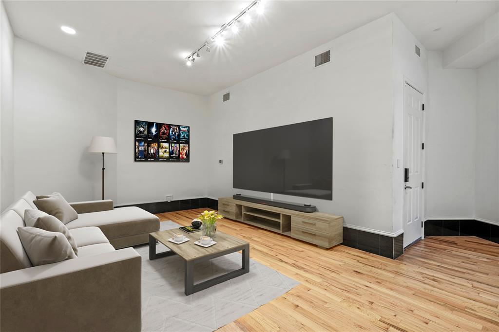 11911 Edgestone Road Dallas, TX 75230 - Photo 11 of 40 Living room with wood finished floors and rail lighting