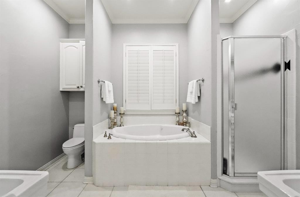 11911 Edgestone Road Dallas, TX 75230 - Photo 16 of 40 Bathroom featuring a bath, a shower stall, crown molding, and tile patterned floors