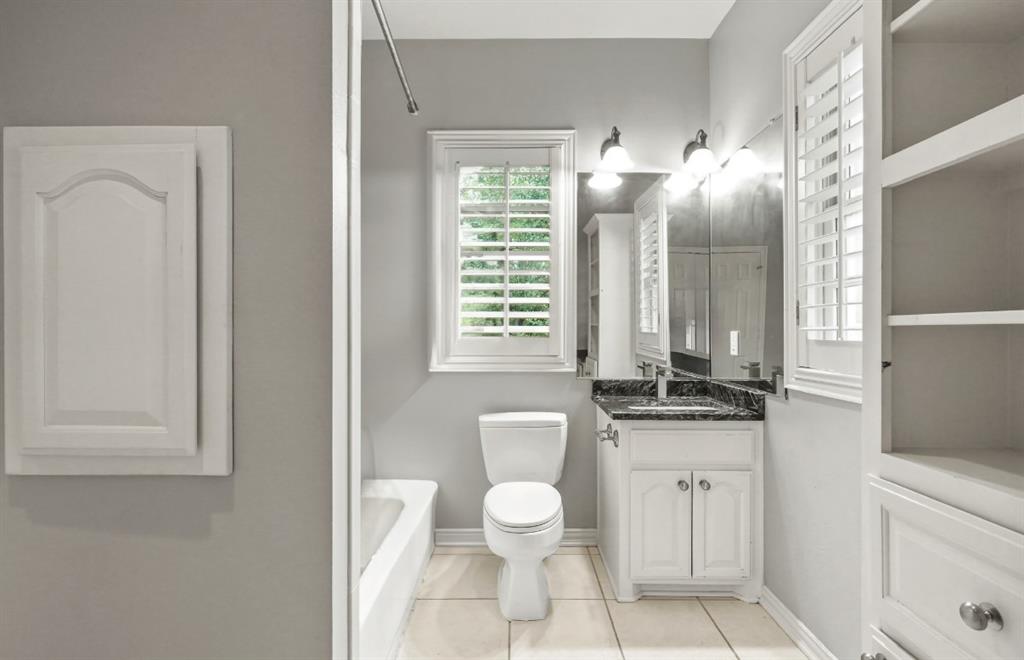 11911 Edgestone Road Dallas, TX 75230 - Photo 24 of 40 Bathroom featuring vanity, a tub to relax in, and tile patterned floors
