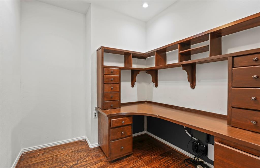 11911 Edgestone Road Dallas, TX 75230 - Photo 29 of 40 Spacious closet featuring dark wood-type flooring and built in desk