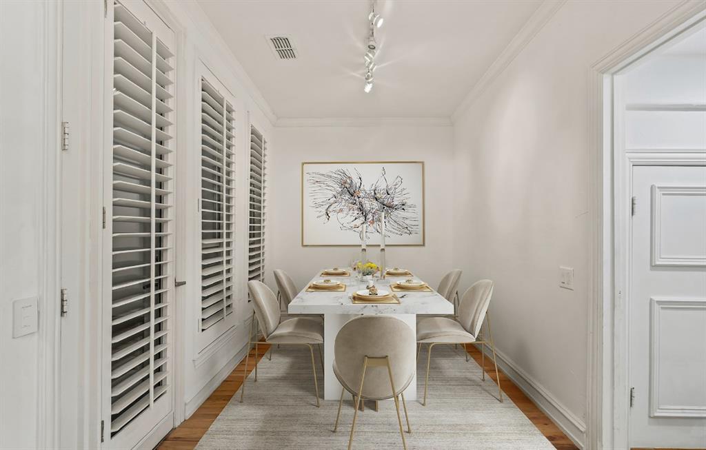 11911 Edgestone Road Dallas, TX 75230 - Photo 9 of 40 Dining room featuring wood finished floors, rail lighting, and ornamental molding