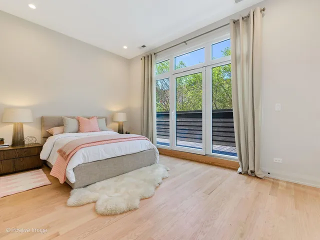 a spacious bedroom with a large bed and a large window