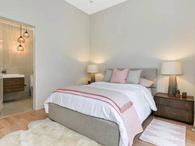 a bedroom with a bed and a lamp