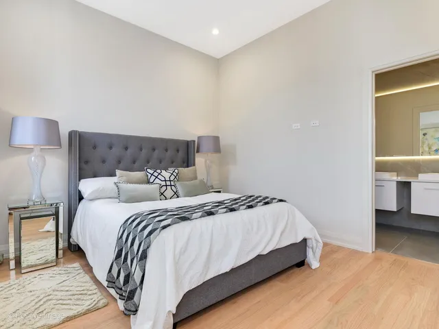 a bedroom with a bed and a lamp