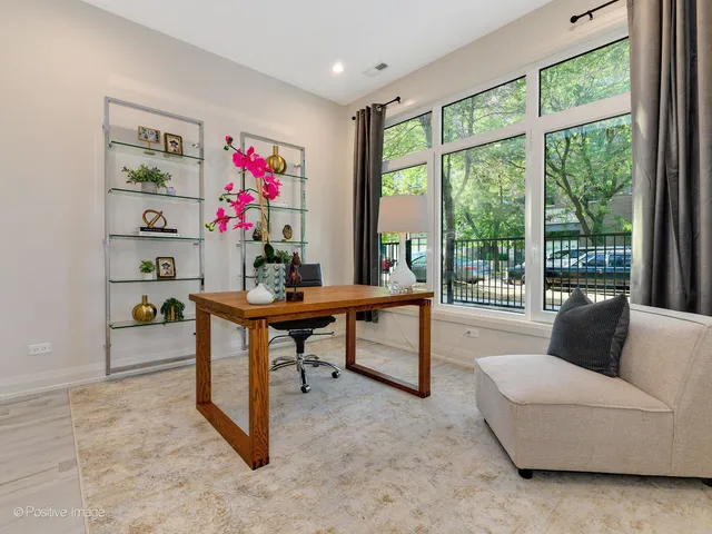 a living room with furniture and a floor to ceiling window