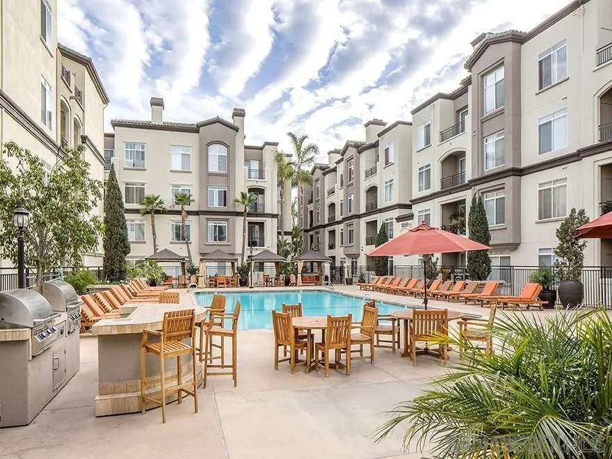 9293 Regents Road, Unit C305 La Jolla, CA 92037 - Photo 19 of 20 a view of a patio with a table and chairs and potted plants