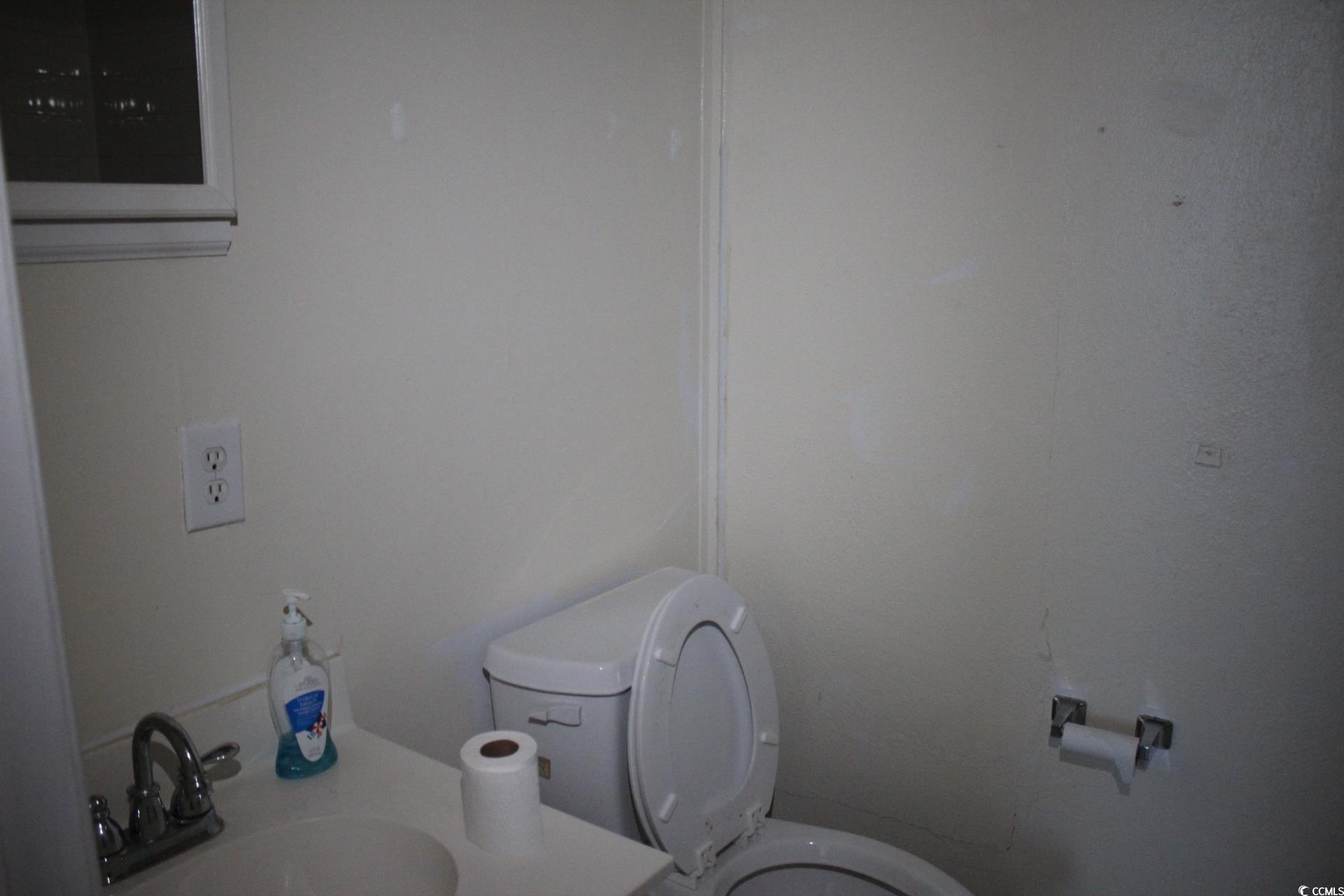 1500 Chester Street, Unit 1 Myrtle Beach, SC 29577 - Photo 8 of 9 Half bath with toilet and vanity