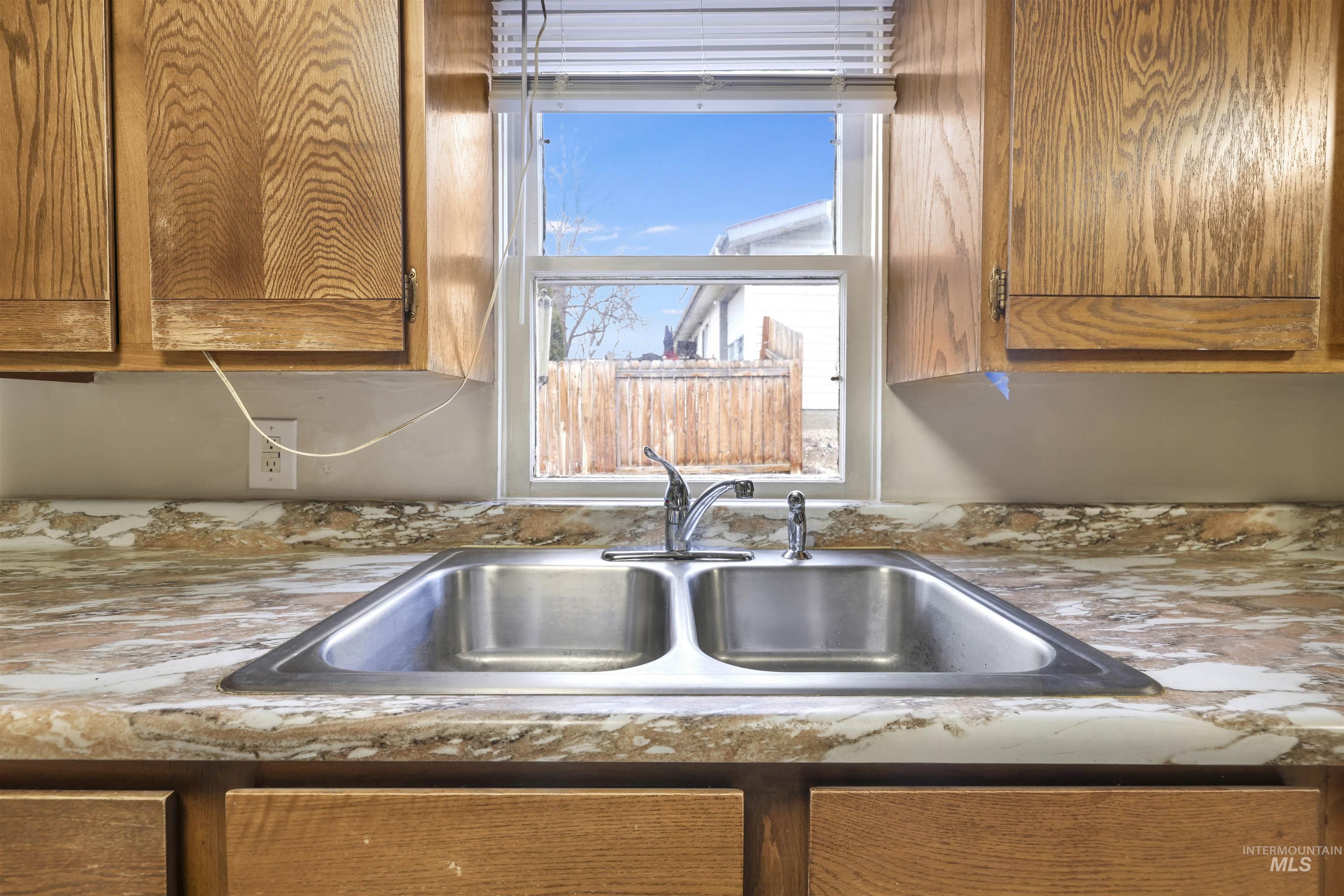 545 Madison Street Twin Falls, ID 83301 - Photo 8 of 23 Kitchen view of brown cabinets and light countertops