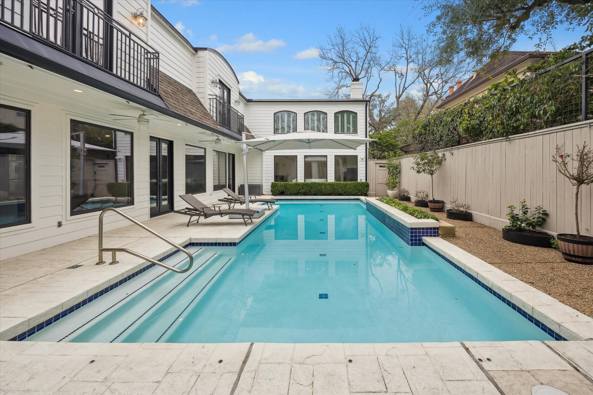 6348 Vanderbilt Street West University Place, TX 77005 - Photo 27 of 30 The backyard is an entertainer's dream. A sparkling pool with lounge areas. Outdoor living experience that feels more like a private resort than a backyard. In West U, outdoor spaces like this are rare, and this one delivers.