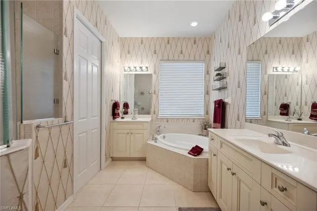 a bathroom with a tub sink and mirror