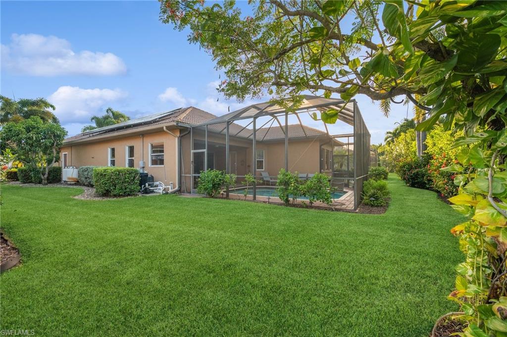 10748 Fieldfair Drive Naples, FL 34119 - Photo 28 of 36 a view of a house next to a big yard and large trees