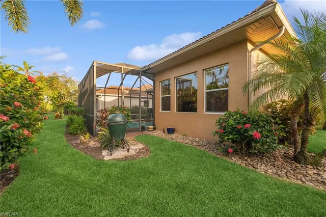 a view of a house with a backyard and a garden