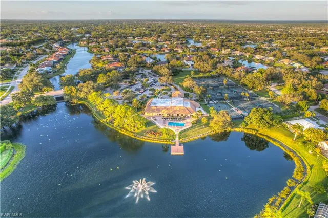 an aerial view of a house with a swimming pool outdoor seating and yard