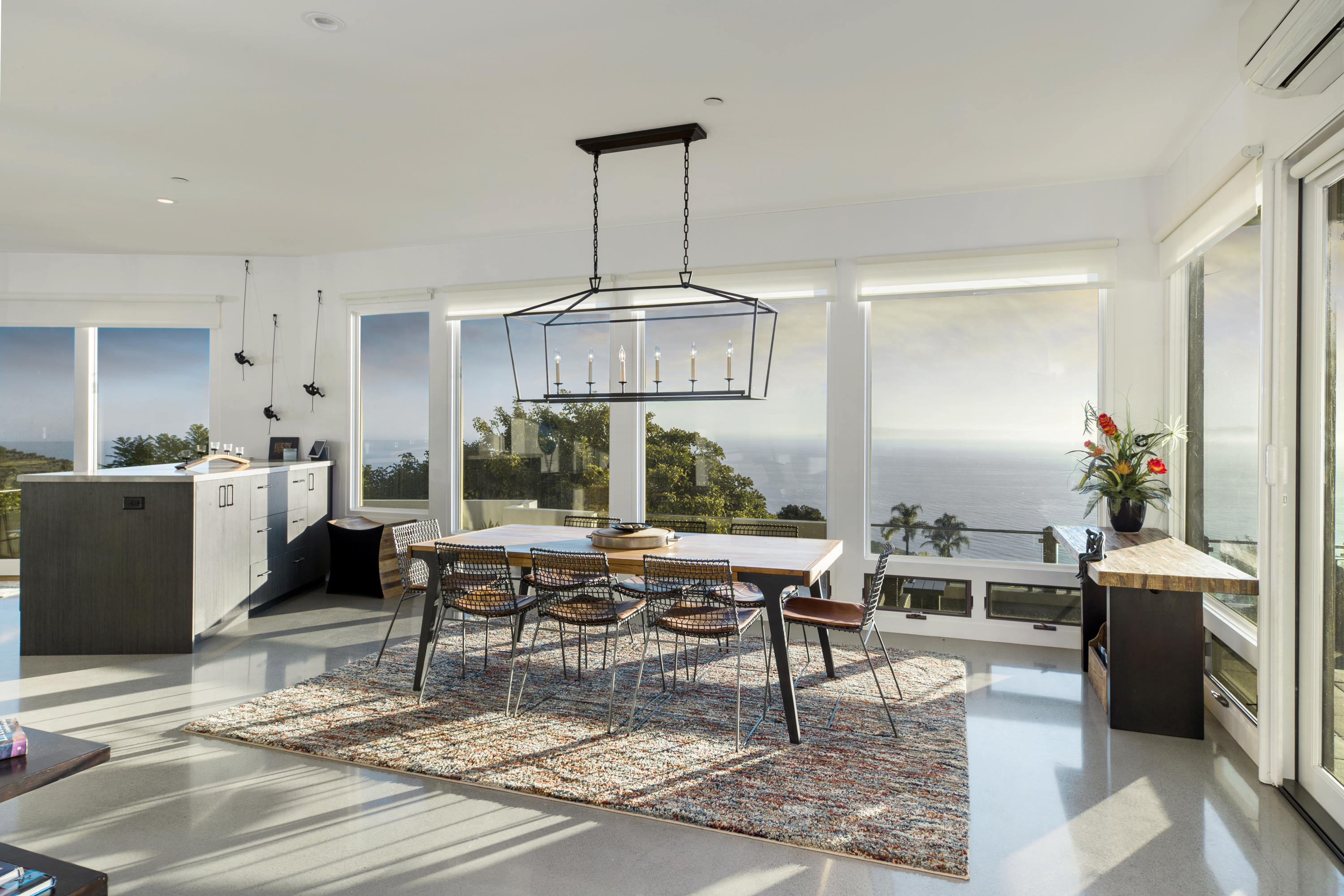 8517 Ocean View Road Ventura, CA 93001 - Photo 14 of 37 a living room with furniture a chandelier and kitchen view