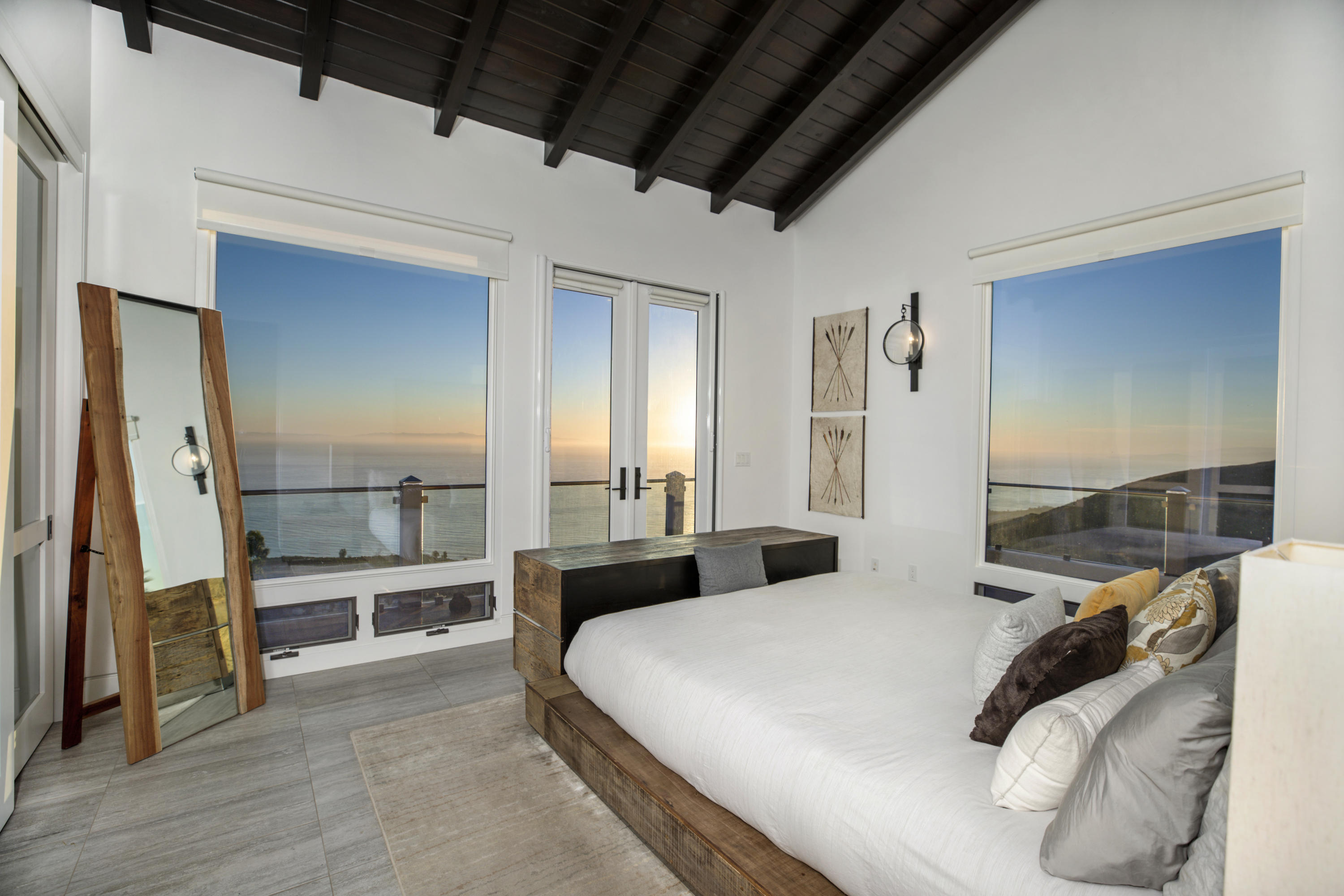 8517 Ocean View Road Ventura, CA 93001 - Photo 23 of 37 a large bedroom with a bed and wooden floor