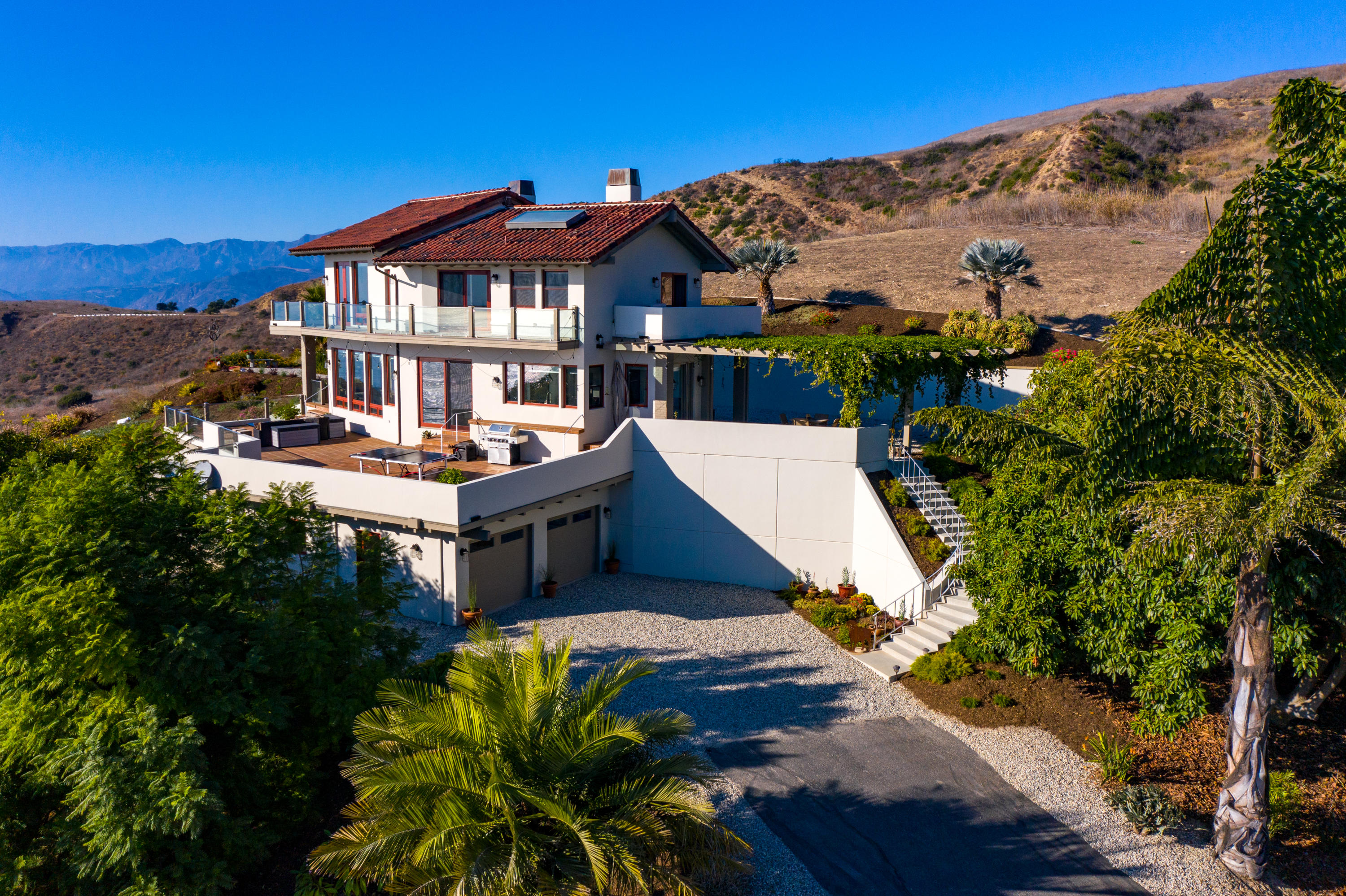 8517 Ocean View Road Ventura, CA 93001 - Photo 7 of 37 a front view of a house with a yard