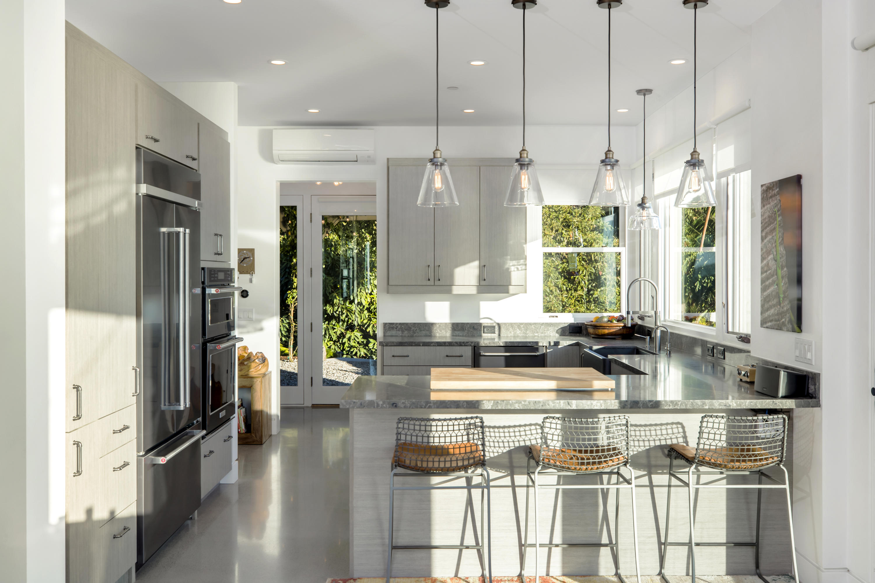 8517 Ocean View Road Ventura, CA 93001 - Photo 9 of 37 a kitchen with stainless steel appliances kitchen island granite countertop a refrigerator a stove and a sink with wooden floor
