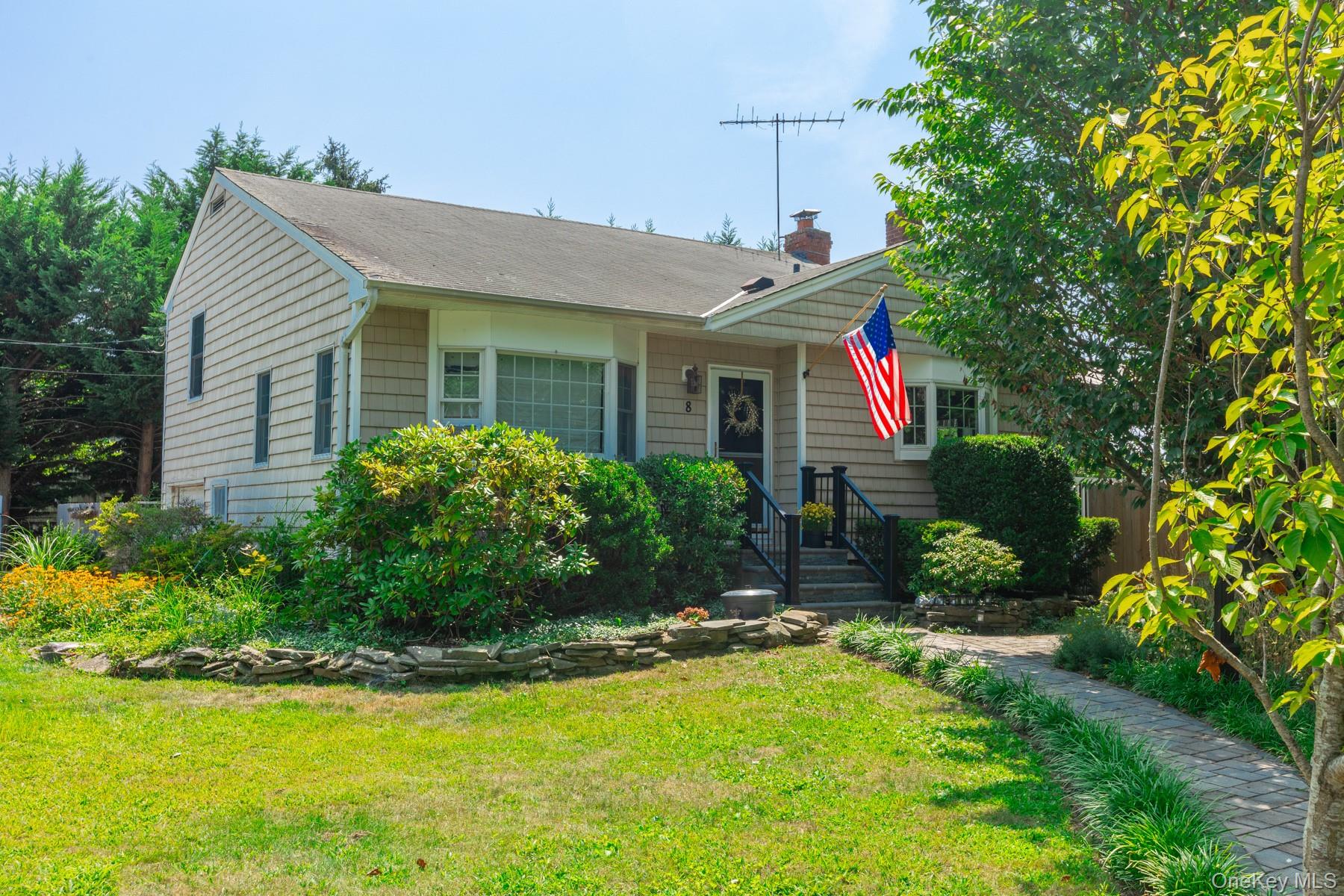View of front of property featuring a front lawn and a chimney